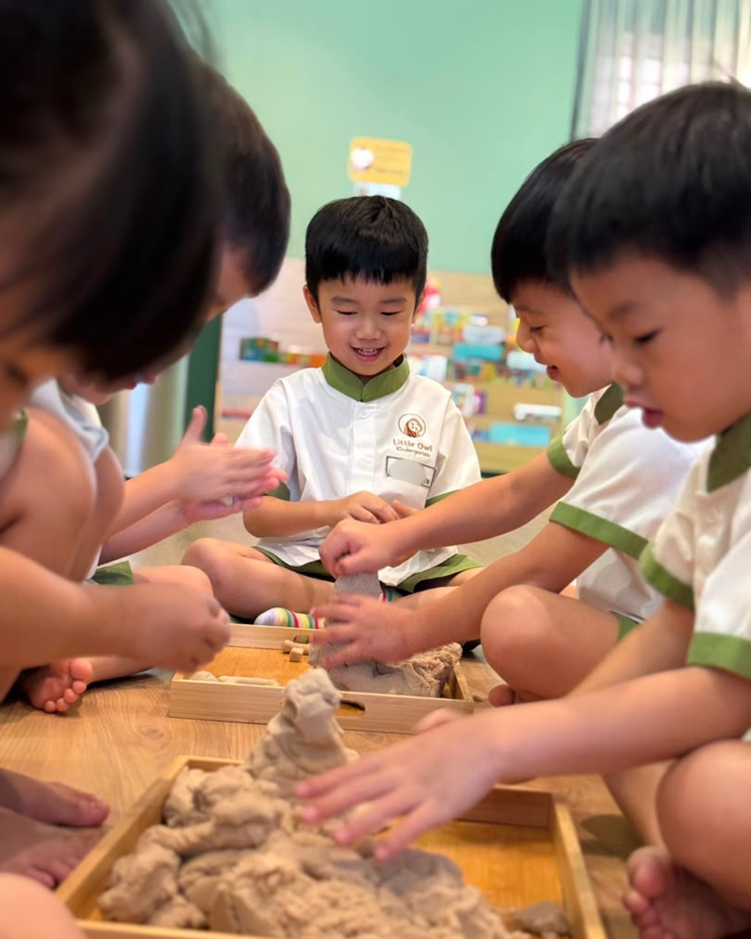 Children exploring a sensory activity together at Little Owl Kindergarten