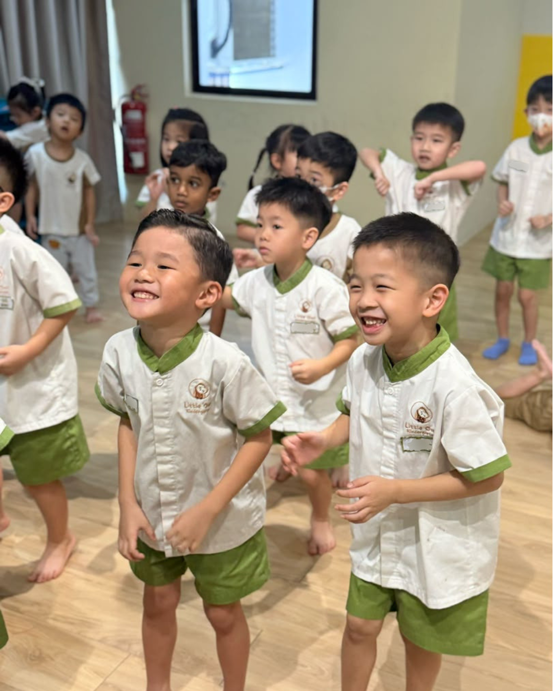 Children at Little Owl Kindergarten smiling during a classroom moment
